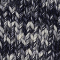 A knit swatch of Wool and The Gang's Crazy Sexy Wool in a variegated dark blue and white colorway. 