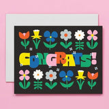 black card with bright colored flowers that reads Congrats!