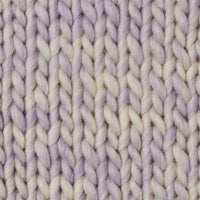 Close-up of a chunky knit swatch  in a variegated soft lilac and cream colorway.