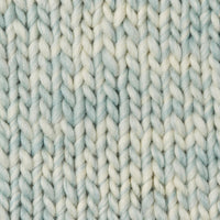 A knit swatch of Wool and the Gang's Crazy Sexy Wool in a light blue and white variegated colorway. 