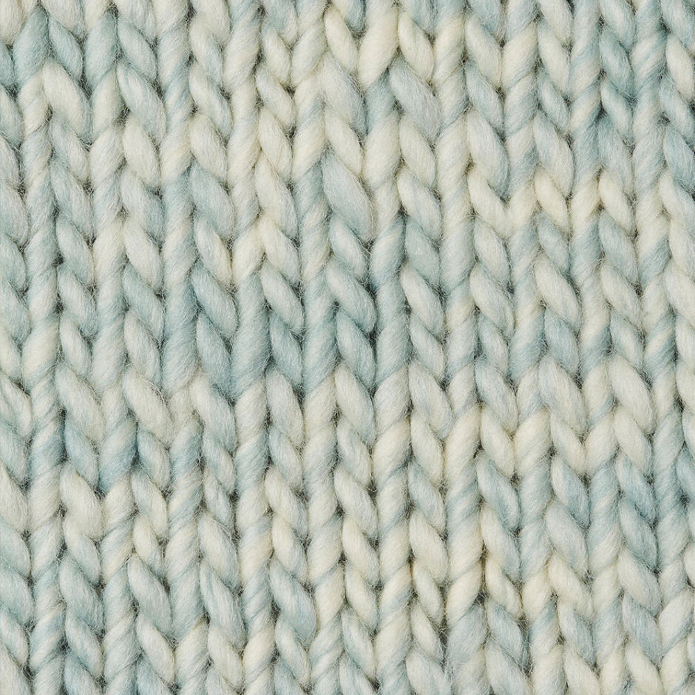 A knit swatch of Wool and the Gang's Crazy Sexy Wool in a light blue and white variegated colorway. 
