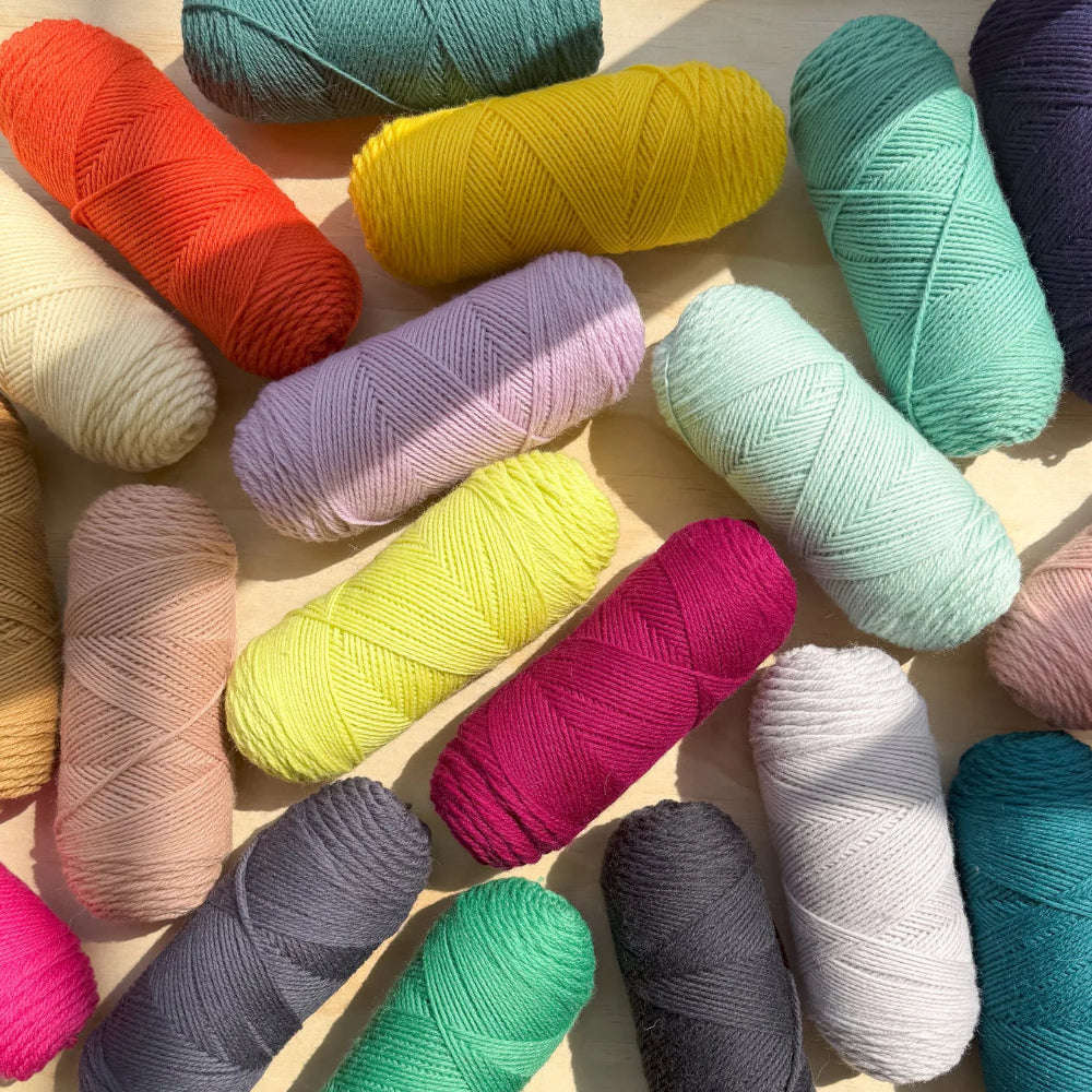 Skeins of various colors against a beige background
