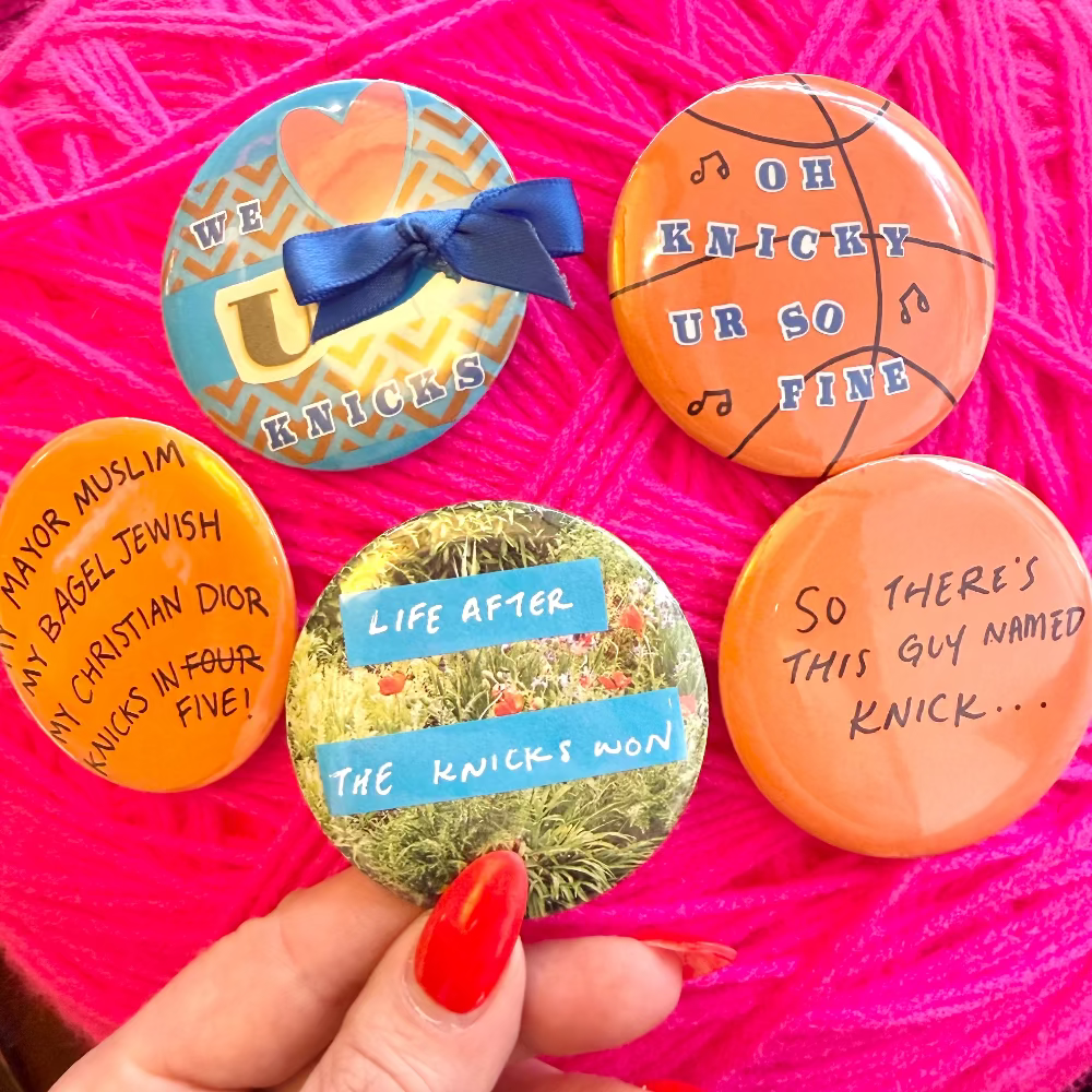 Five colorful buttons with humorous text on a pink yarn background