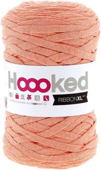 Spool of apricot yarn with 'Hoooked' label on a white background