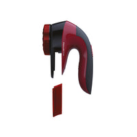 Side view of red and black lint remover on a white background