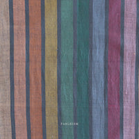 Striped fabric with multicolor pattern on a dark background and 'Fableism' branding.