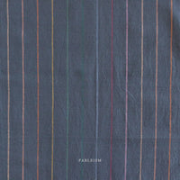 Textured dark fabric with multicolored vertical stripes and 'Fableism' branding.