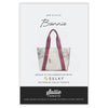 Sewing pattern with picture of white floral tote bag with pink straps on a white background