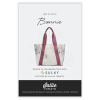 Sewing pattern with picture of white floral tote bag with pink straps on a white background