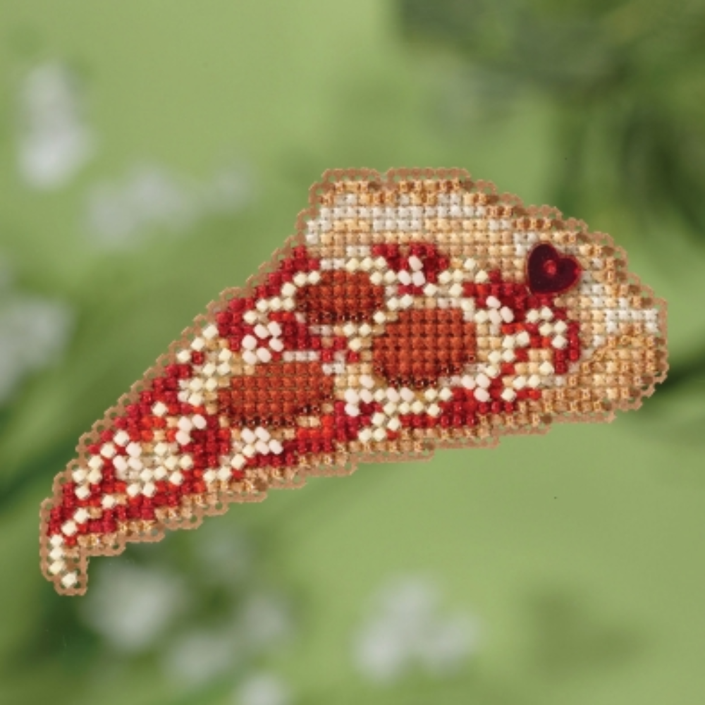 beaded pizza ornament on green background