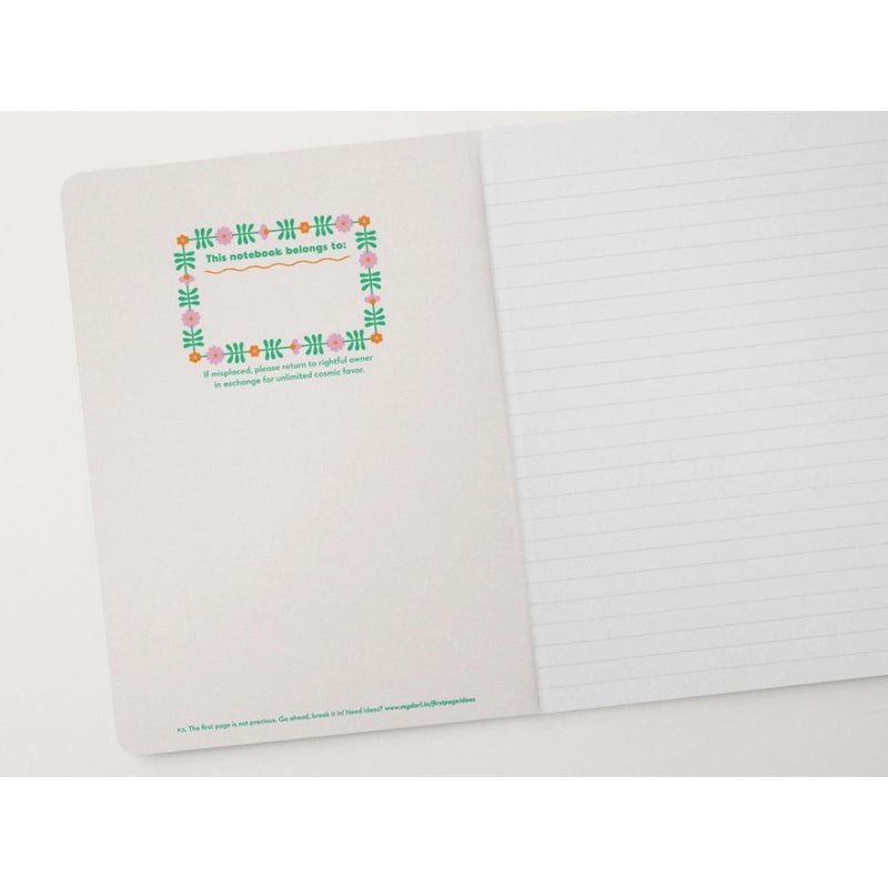 Notebook with decorative cover and lined pages on a white background