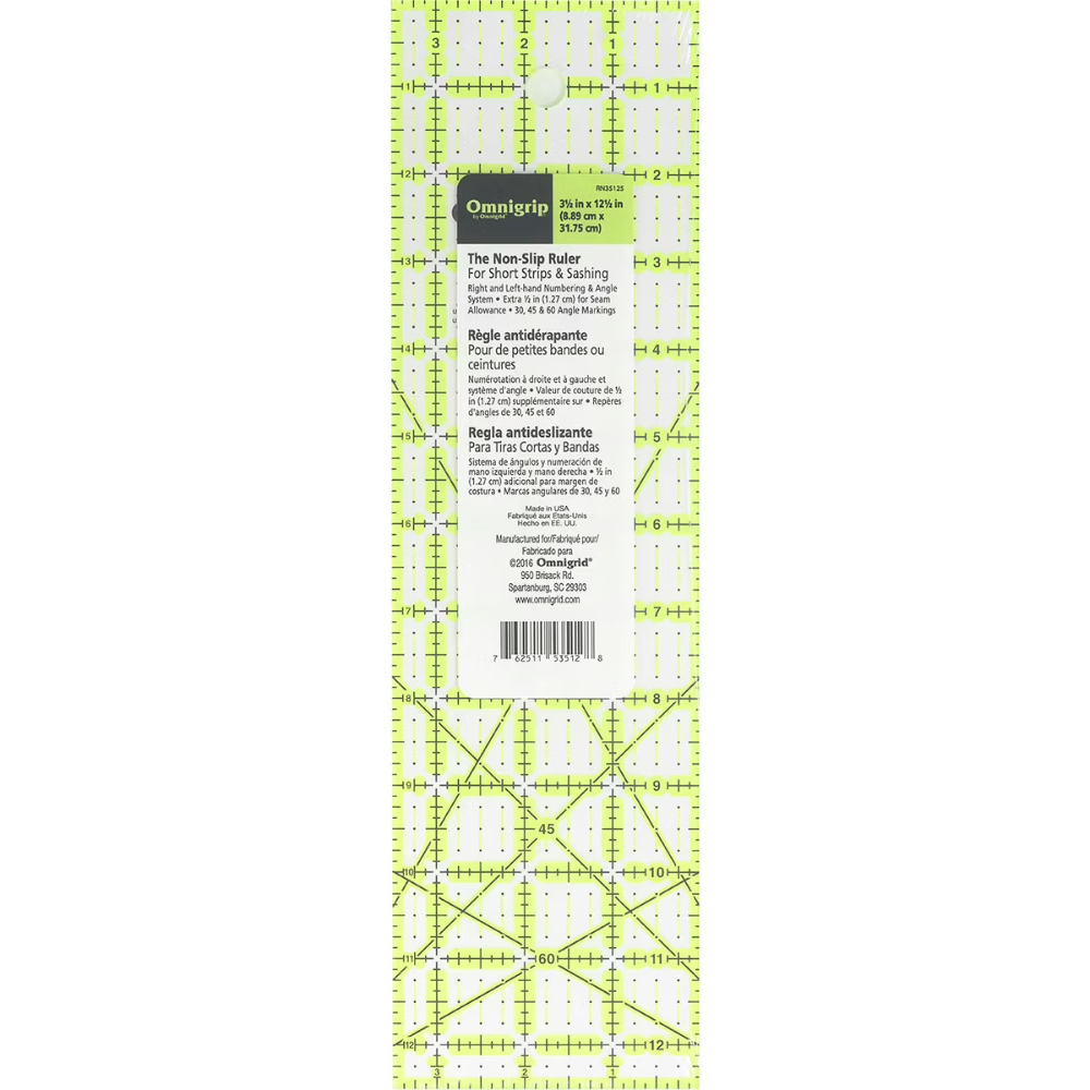 A clear ruler with a neon green grid is displayed against a white background. Their is a white label with text that reads "Omnigrip" along with "3.5 in x 12.5 in" (8.89 cm x 31.75 cm). Lower text reads "The Non-Slip Ruler for Short Strips and Sashing". 