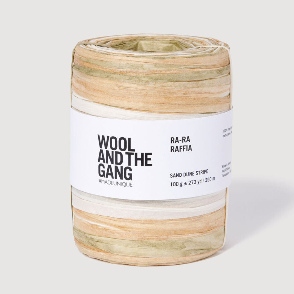 Spool of RA-RA Raffia with tan, green, and white stripes by Wool and the Gang on a white background