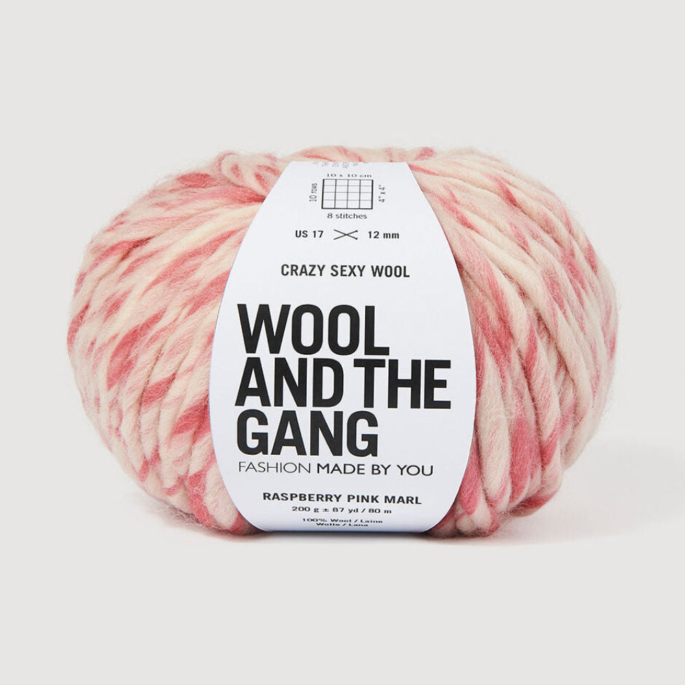 A single ball of variegated  pink and white yarn with a white paper label reading 'Wool and the Gang' on a light gray background.