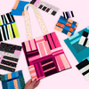 Colorful geometric-patterned tote bag held by a hand with fabric swatches in the background.