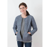 image of a white woman wearing a slate grey version of the Tamarack Jacket 