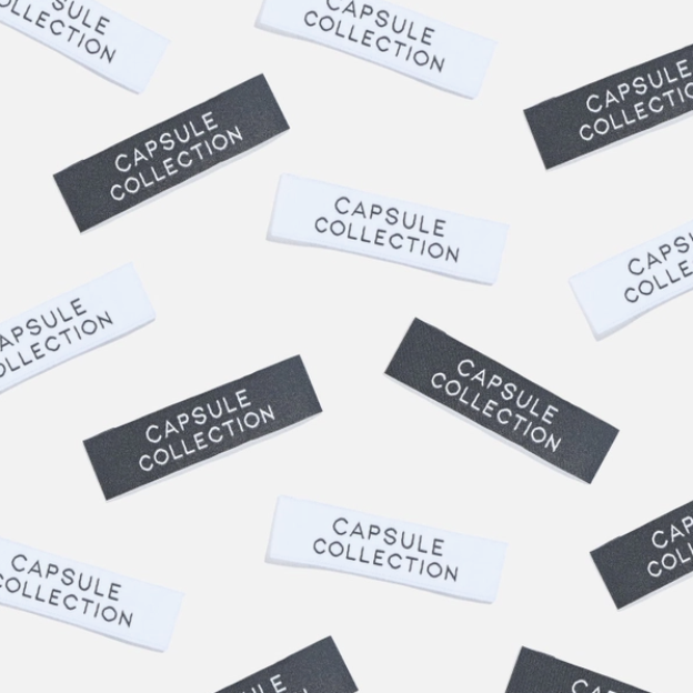 display image of fabric labels in black and white colors that say "capsule collection"