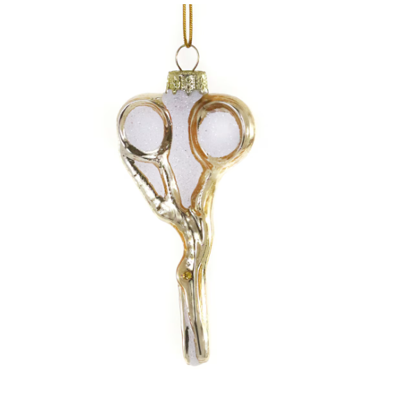 Decorative glass ornament shaped like a pair of scissors with gold accents on a white background