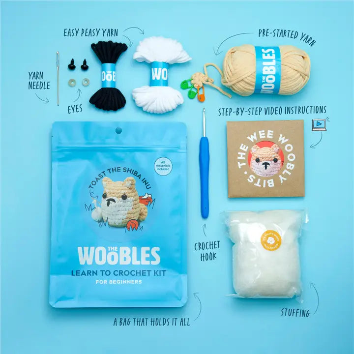 Kit content including the pouch, yarn, instructions, tapestry needle, stuffing, plastic eyes, stitch markers and crochet hook.