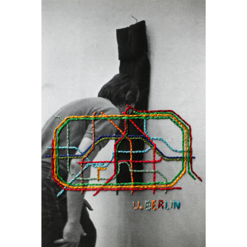 embroidered photo of a person wearing a sweater with colorful geometric design and 'U.Berlin' text.