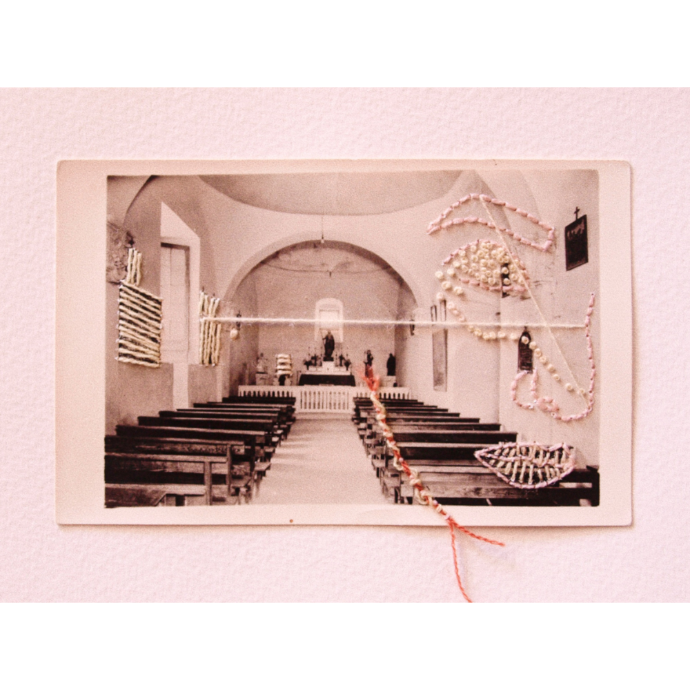 Vintage-style photo of a church interior with pews and a cross, framed against a pink background.