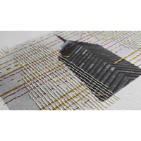 Close-up of woven photo with white and gold patterns 