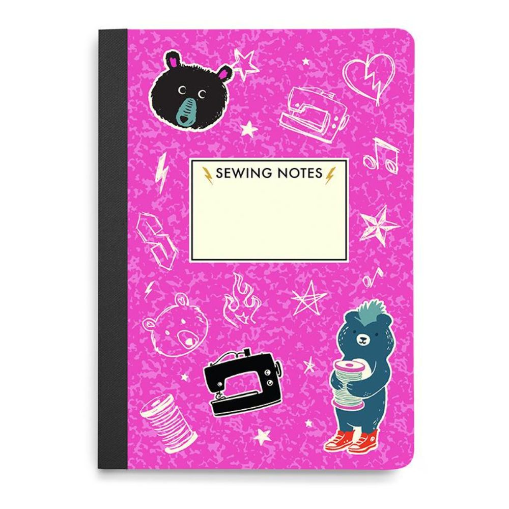 Notebook with pink cover featuring sewing-themed illustrations and a bear character.