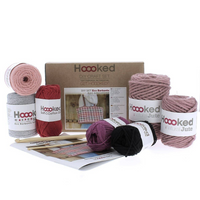 Crochet bag kit packaging with pink, red, black, and gray yarn