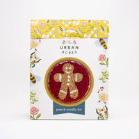 Punch needle kit packaging with a gingerbread man design on a white background
