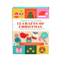 A boxed craft kit titled "Advent Calendar 12 Crafts of Christmas" shown on a plain white background. The box features colorful holiday illustrations including ornaments, a Christmas tree, a Santa hat, pom-poms, candy canes, a gift, stars, and a wreath.