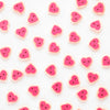 Pattern of pink heart-shaped buttons on a white background
