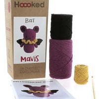 Crochet kit with yarn, pattern, and packaging for 'Bat Mavis' by Hoooked on a white background.