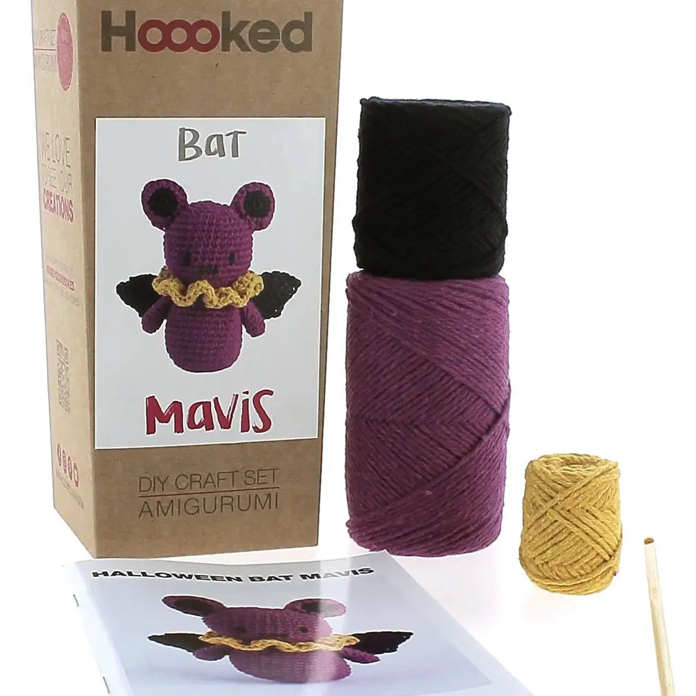 Crochet kit with yarn, pattern, and packaging for 'Bat Mavis' by Hoooked on a white background.