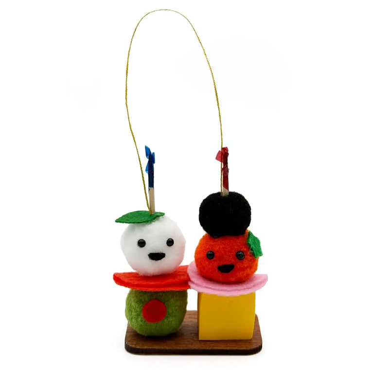Multicolor antipasto with smiling faces pom pom ornament on a white background.
