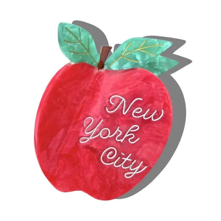 Hair claw clip in the shape of a red apple with white text reading "New York City"