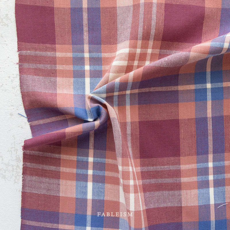 Plaid fabric with shades of purple, blue, and pink on a white background, featuring the brand 'Fabletics'.