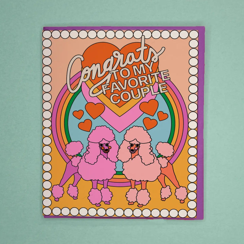 Card with pink poodles, rainbow, and hearts on a teal background