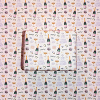 Patterned paper with champagne bottle, glass, and 'party!' text design.