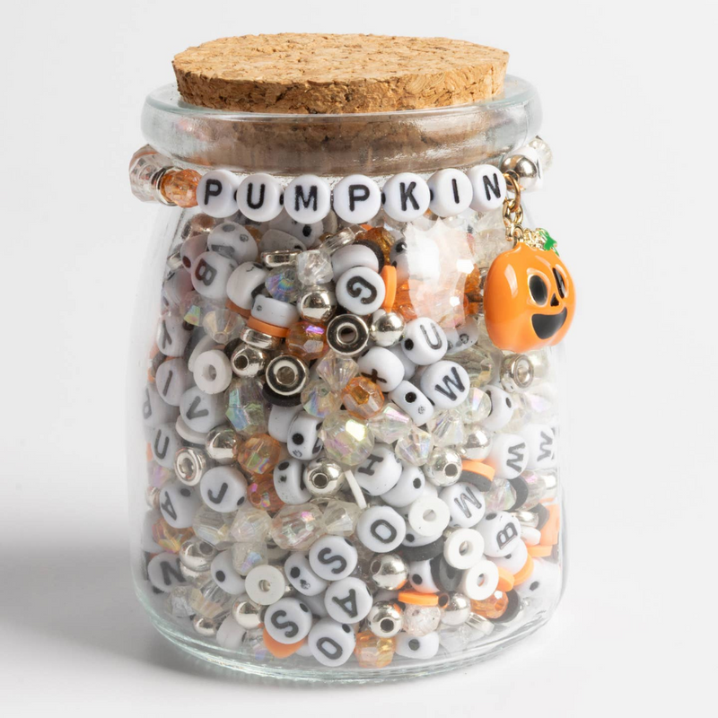 glass jar with orange, back, silver, and letter beads. On the front a bracelet reads "pumpkin" with an enamel pumpkin charm.