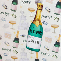 Personalized champagne bottle gift tag with 'Mr & Mrs' and 'Julia' text on a festive background.