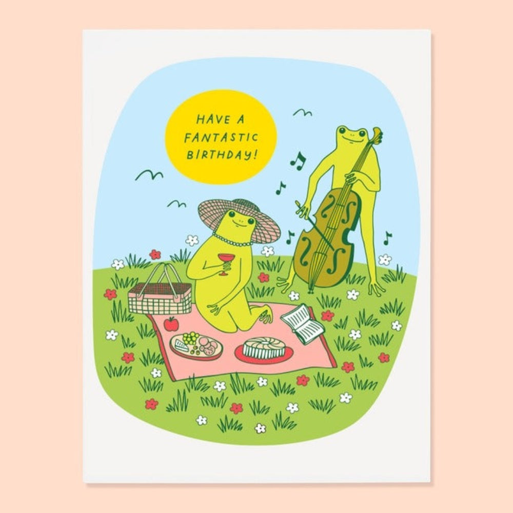 Illustration of two frogs having a picnic with a cello, on a card that says 'Have a Fantastic Birthday!'.