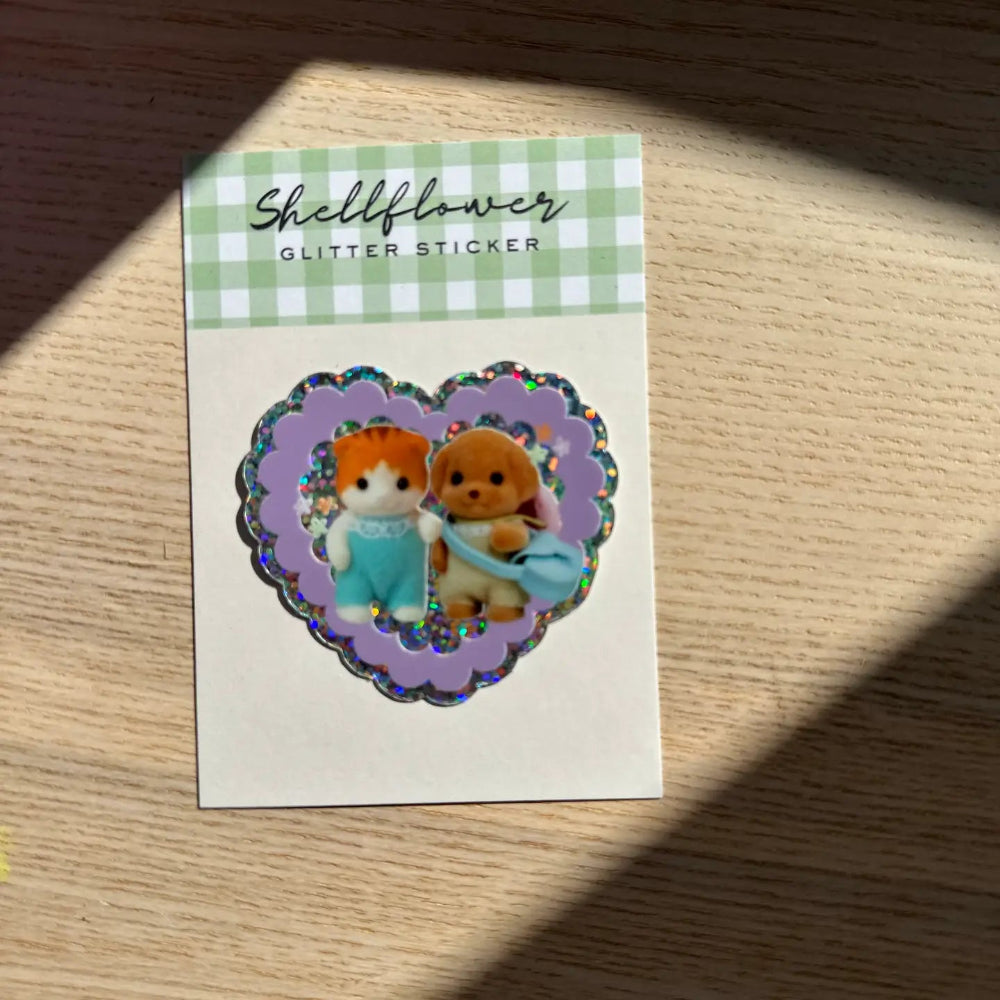 Glitter sticker with two cartoon characters on a purple background