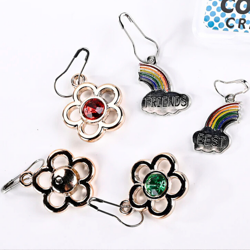 Silver metal stitch markers: 3 flowers and 2 rainbow. One rainbow reads "best," the other reads "friends