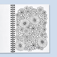 Coloring book with black floral patterns on a white cover against a light blue background