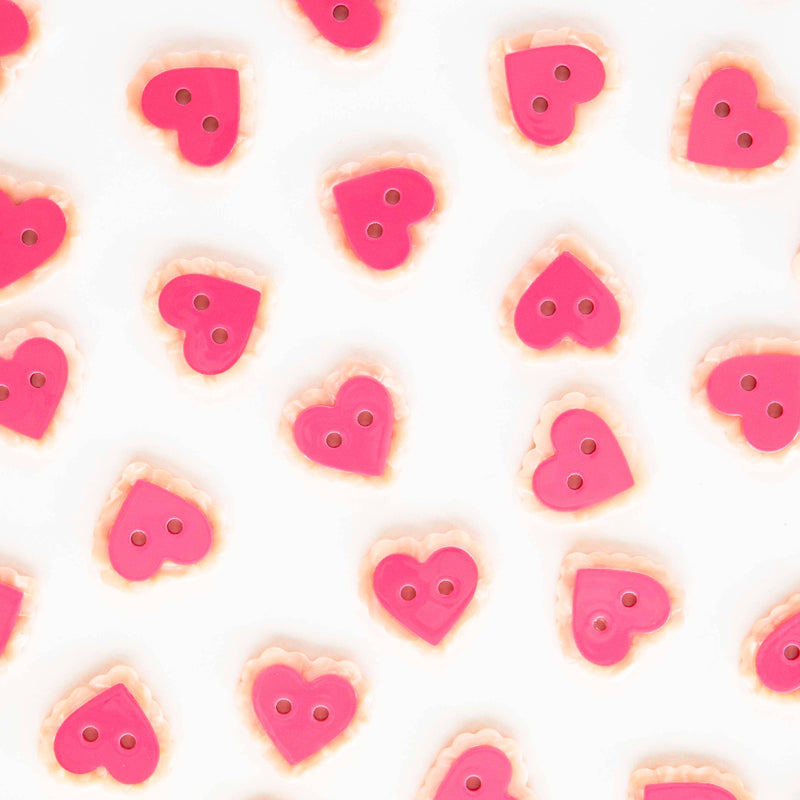 Pattern of pink heart-shaped buttons on a white background
