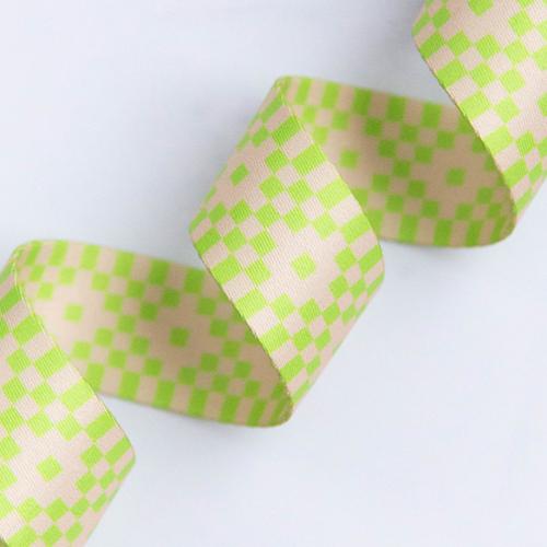 Checkered webbing with green and beige pattern on a white background