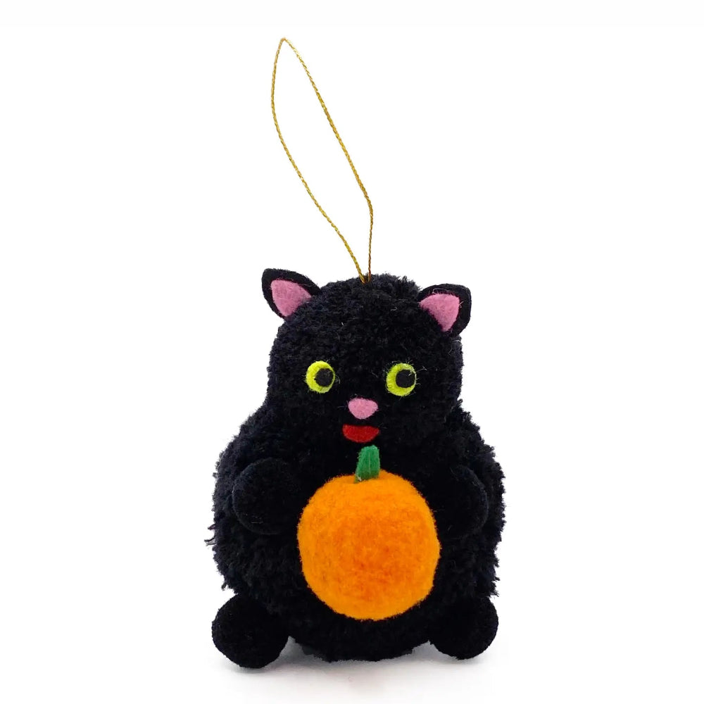 A black plush cat ornament holding a bright orange pumpkin, featuring pink inner ears, yellow eyes, and a gold hanging loop, set against a plain white background.