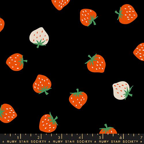 black fabric with red and white large strawberries on top 