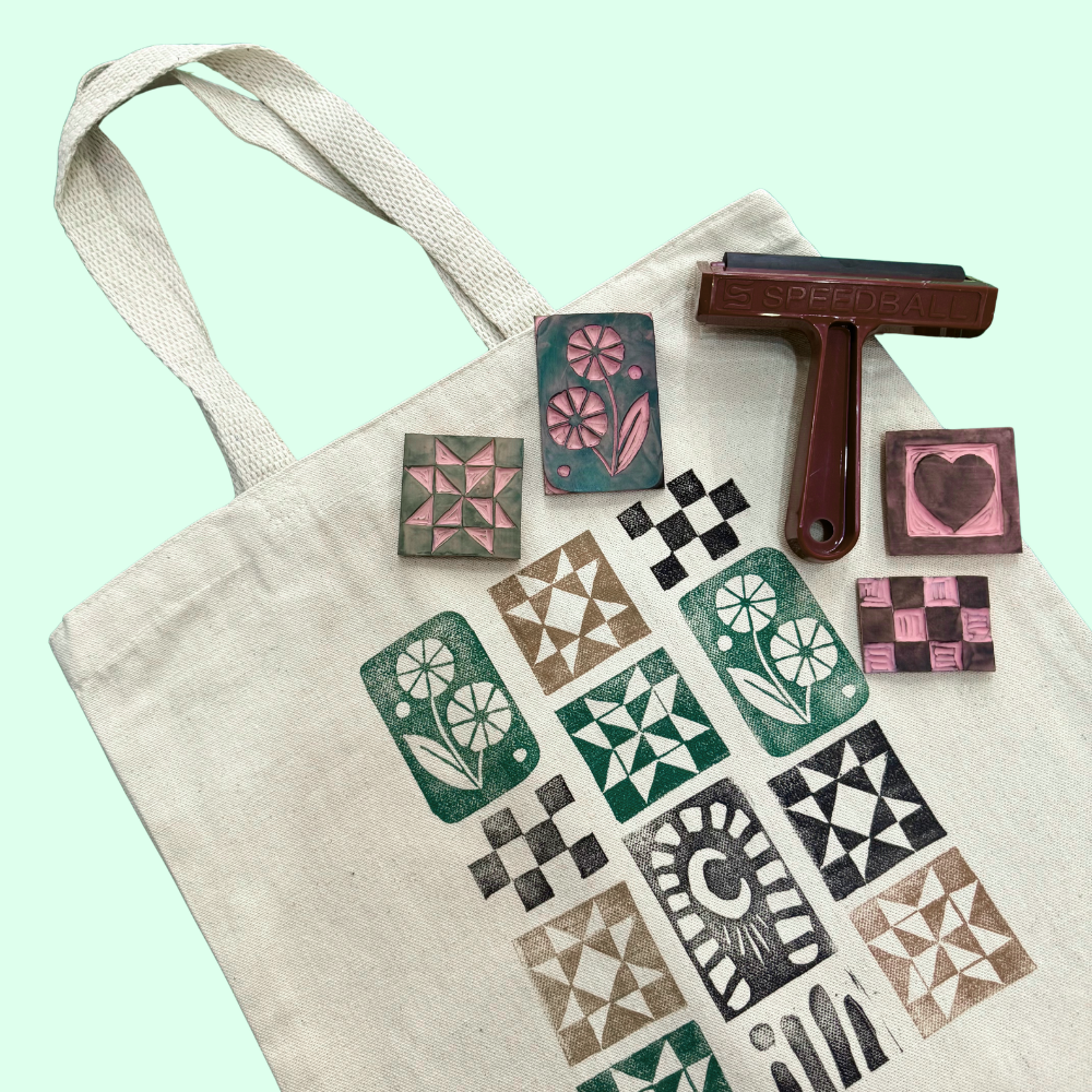 Tote bag with printed patterns and stamping tools on a light green background
