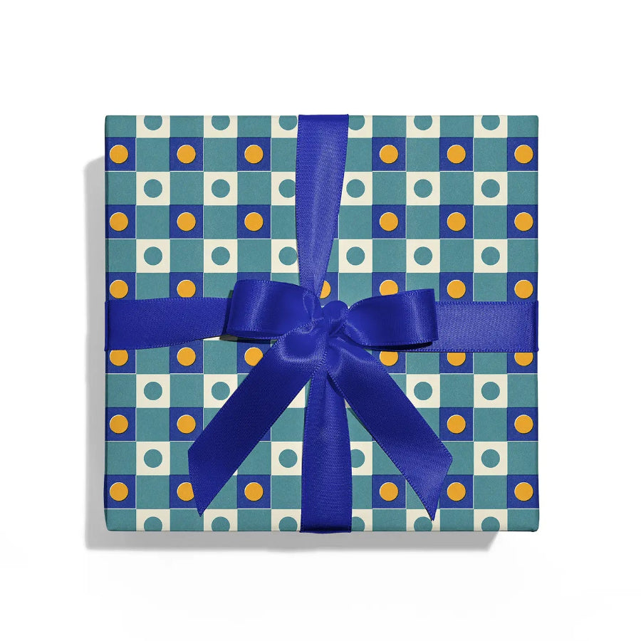 Gift box with blue ribbon and blue and white patterned wrapping paper